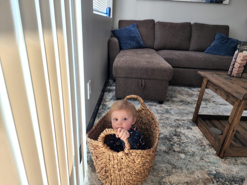 baby in a basket at lakefront cabin