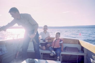 family in a boat on the lake